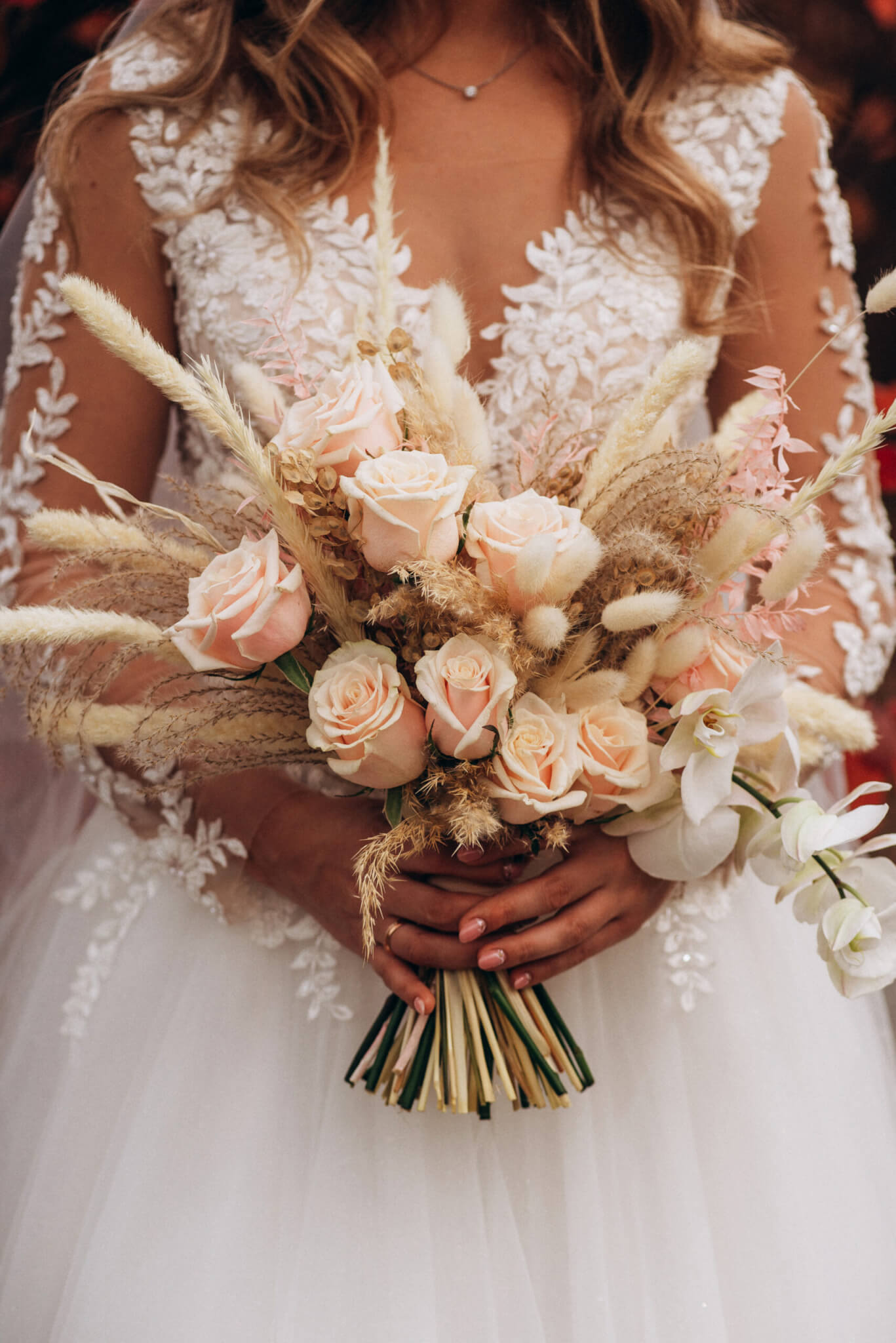 Bride holding a beautiful pink flower bouquet