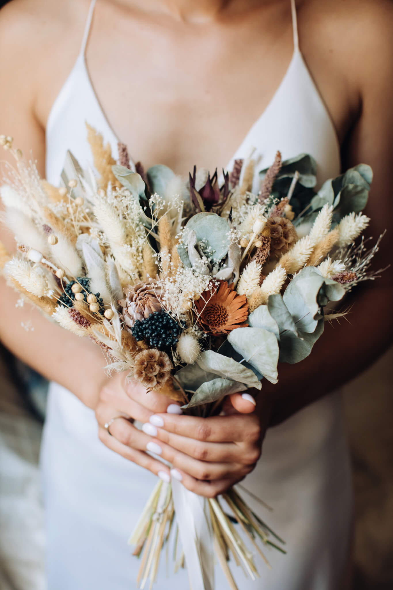 Bride holding a heart shaped bouquet of flowers