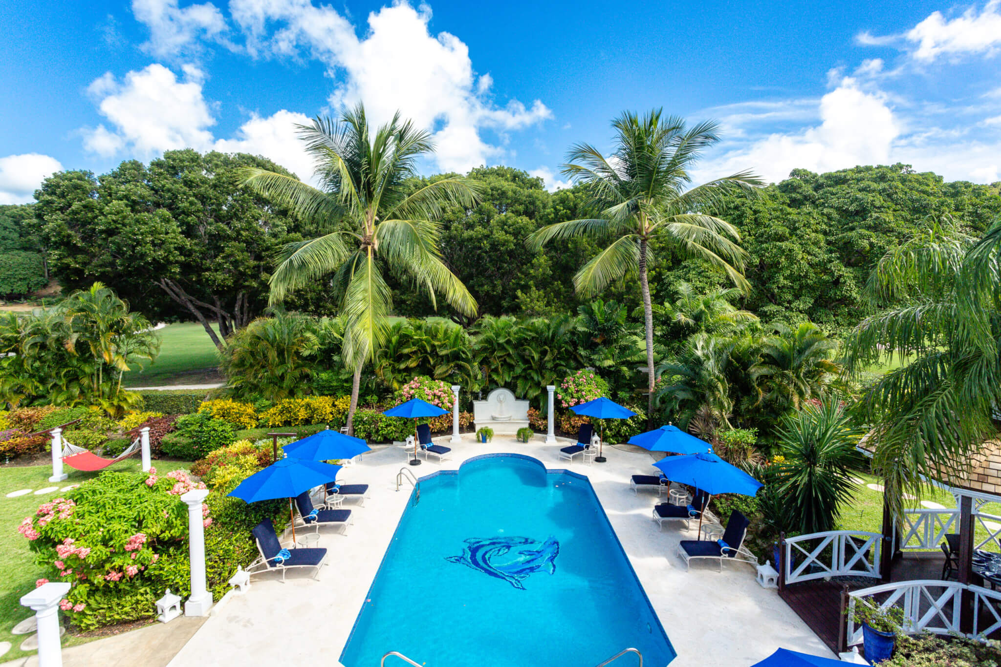 Overlooking the entire back garden from a balcony above the pool